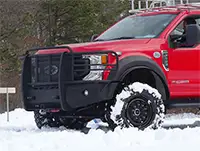 Red fire truck with black Founders tires in snow