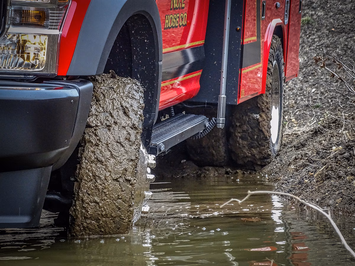 Red fire truck crossing water