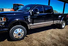 Truck with Founders tires driving through mud
