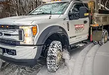 Dump truck plowing snow with Founders tires