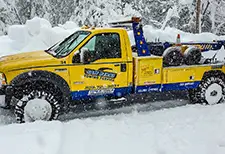 Tow truck in snow with Founders tires