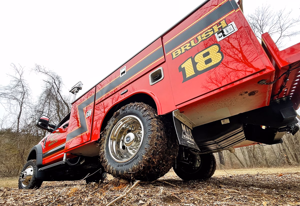 Red work truck in mud
